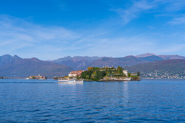 Lake Maggiore at Stresa, view over the lake to Isola Bella - island Bella with a ferry, background the alps in Italy