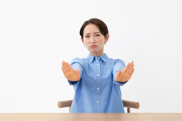 ハンドサインで拒否をする女性