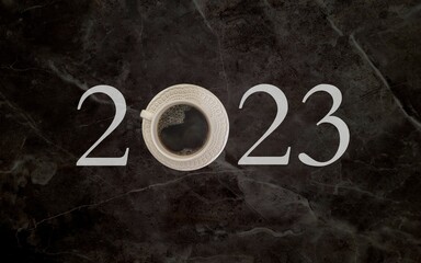 coffee with white cup with dark background written 2023, happy new year 2023
