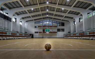 Basketball ball placed on court floor in the basketball gym. View from Empty basketball gym, Space for text, Selective focus. © num