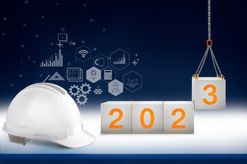 engineer working table and lifting concrete cube by crane construction for welcome 2023 new year,...