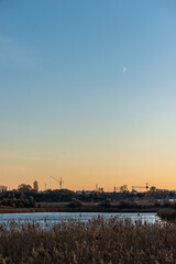 Fototapeta premium sunset over the lake in forest with moon at autumn evening 