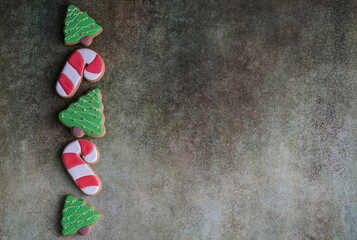 Top view of christmas cookies on gray background with space for christmas greetings. Gingerbread in the shape of a Christmas tree. Christmas banner