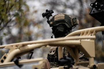 The silhouette head of a military soldier equipped with protective helmet and night vision equipment. Military industry and army details.