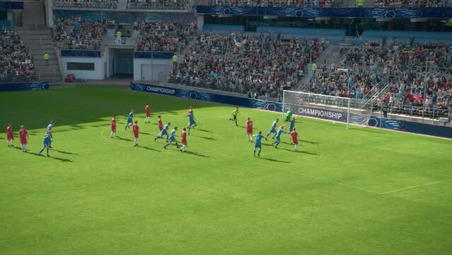 Football Championship: Blue Team Forward Shots Shootout Penalty, Kicks the Ball and Scores the Goal. Winning the Match and Game, Players Celebrate Tournament Victory. High Angle Wide Shot