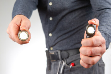 man holds a flashlight in his hand. item for camping and household life