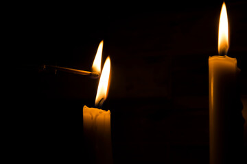 A burning match, a match lights up from a candle, a candle and a match