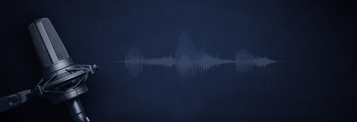 Recording studio microphone with audio waveform and copy space on dark blue background....