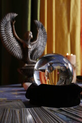 Fortune teller's table with crystal ball, incense, candles and other occult objects