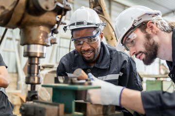 Team of engineers practicing maintenance Taking care and practicing maintenance of old machines in the factory so that they can be used continuously.