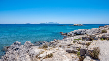 Fototapeta na wymiar View over wide blue ocean from a rocky coastline
