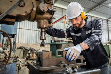 Team of engineers practicing maintenance Taking care and practicing maintenance of old machines in the factory so that they can be used continuously.