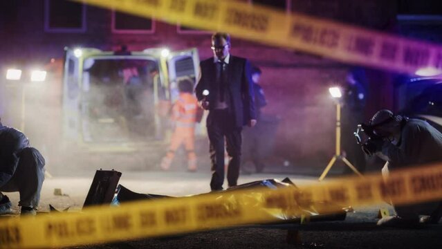 "Do-not-Cross" Tapes Restricting Access to Crime Scene in a Back Alley. Detective Inspecting the Body and Thinking About the Murderer's Motive. Smart Investigator Relating the Case to a Serial Killer