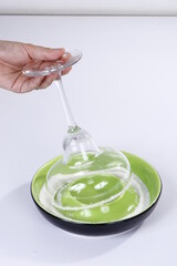 Salt being placed on cocktail glass