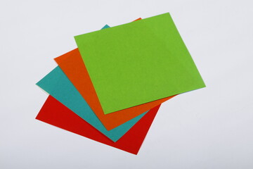 Colorful square origami paper sheets on a white background