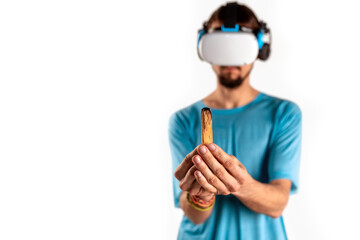 Close-up man holding in his hand a piece of Palo Santo wood in a virtual reality helmet on a light background