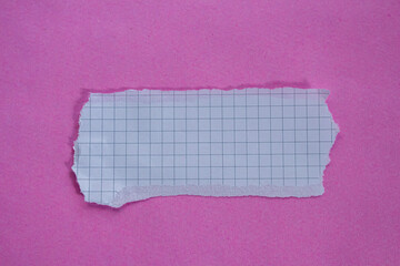 White checkered paper on pink background, top view. Copy space.
