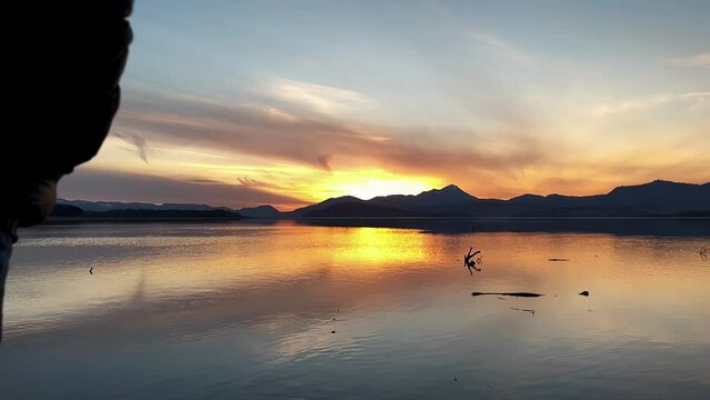 man walking on water at sunset.