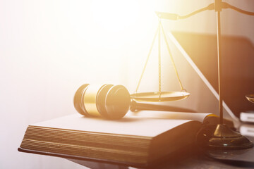 Justice and law concept.Male judge in a courtroom with the gavel, working with, computer and...