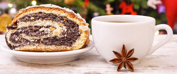 Fresh baked poppy seeds cake, coffee or tea and christmas tree with lights and decoration