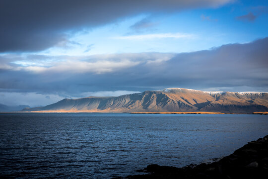 Landscape with Mount Esja and Atlantic ocean coastline in Reykjavik, Iceland. No people, blue cloudy sky. 