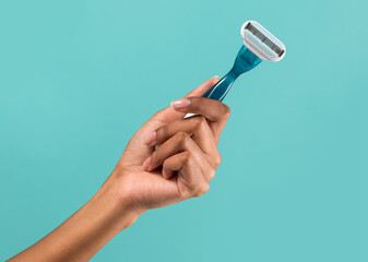 Female hand showing disposable razor