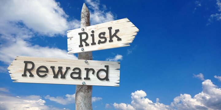 Risk and reward - wooden signpost with two arrows