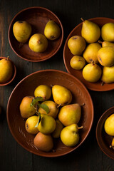 Ripe juicy pears in ceramic bowls, top view