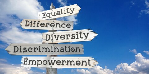 Equality, difference, diversity, discrimination, empowerment - wooden signpost with five arrows