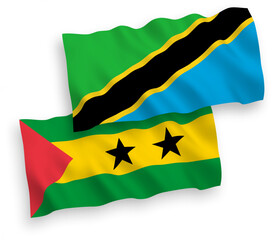 National vector fabric wave flags of Saint Thomas and Prince and Tanzania isolated on white background. 1 to 2 proportion.