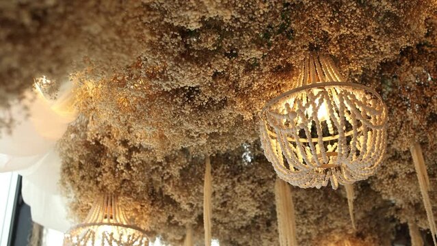 a beautiful wooden chandelier on a decorative ceiling