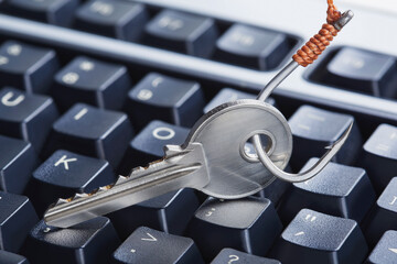 phishing, hacking personal data and money , key and hook on computer keyboard.