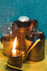 Lights off or power outage in Ukraine - burning candle and dead dark electricity lamps off 