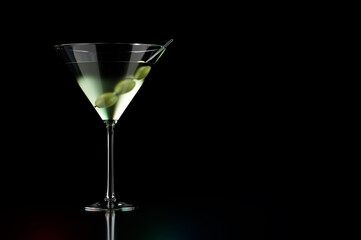 Martini cocktails with olives on black background