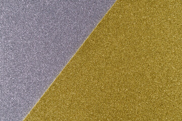 Background of shiny gray and golden paper in bright colors, geometric pattern