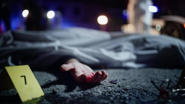 Close Up Low Angle: A Corpse with a Bloody Hand Lying on the Floor and Covered. Gruesome Murder Case Leaving Victim for Dead. Forensics Taking Photos Before Body is Taken to Morgue. Cinematic Shot