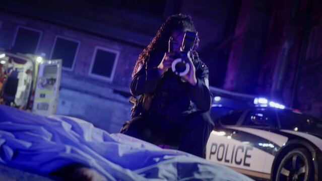 Black Female Police Officer Investigating a Murder Case at a Crime Scene. Policewoman Taking Photos of the Corpse and Preparing a File on Domestic Violence Case. Forensics at Work, Detective on Duty