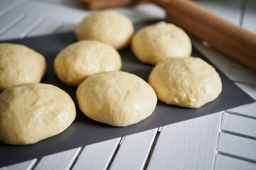 Pizzeria. Dough balls preparation concept. Fresh raw dough. Preparing pizza dough on a table at kitchen at home. High quality image