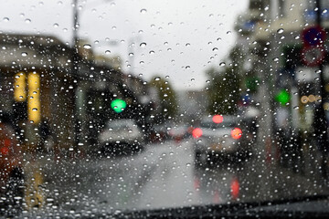 driver's view of the city on a rainy day
