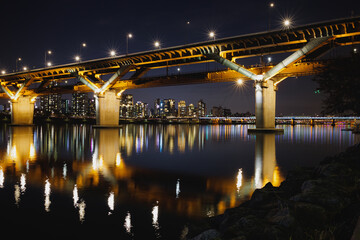 Fototapeta na wymiar Night view of Han River in Seoul, Cheongdam Bridge and lights reflected in the calm Han River