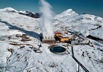 Aerial view to geothermal power plant in mountain. Clean green renewable energy in Kamchatka. - 550636303