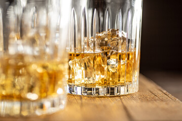 Whisky glasses. Wooden background. Close up.