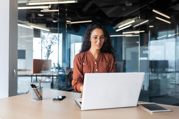 Cheerful and successful indian woman programmer at work inside modern office, tech support worker...