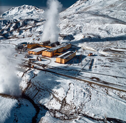 Aerial view to geothermal power plant in mountain. Clean green renewable energy in Kamchatka. - 550638588