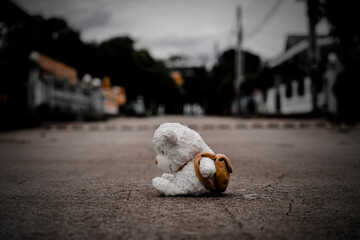lonely teddy bear sleep on cement floor for created postcard  of international missing children, broken heart, lonely, sad, alone unwanted cute doll lost. - 550639741