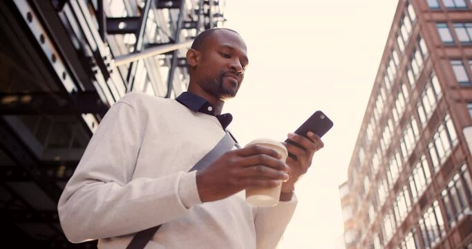 Phone, coffee and city with a business black man outdoor for travel or commute with flare from below. Contact, mobile and communication with a male employee using 5g for GPS navigation or directions