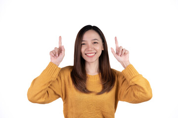 Young beautiful smiling good mood positive girl pointing finger in copyspace isolated on white background.