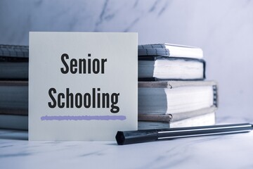 White card with the text Senior Schooling on study desk. 