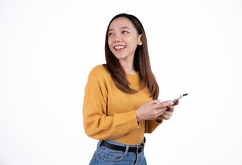 Portrait of a smiling casual asian woman holding smartphone over white background.