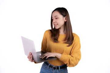 Naklejka premium Portrait of a happy asian businesswoman holding laptop computer and looking away isolated over white background.